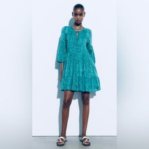 Turquoise and green mini-dress embellished with gold metallic thread.